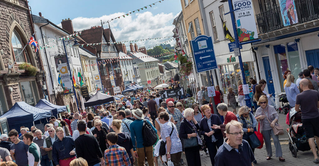 Abergavenny high street on a busy day in the sunshine. 